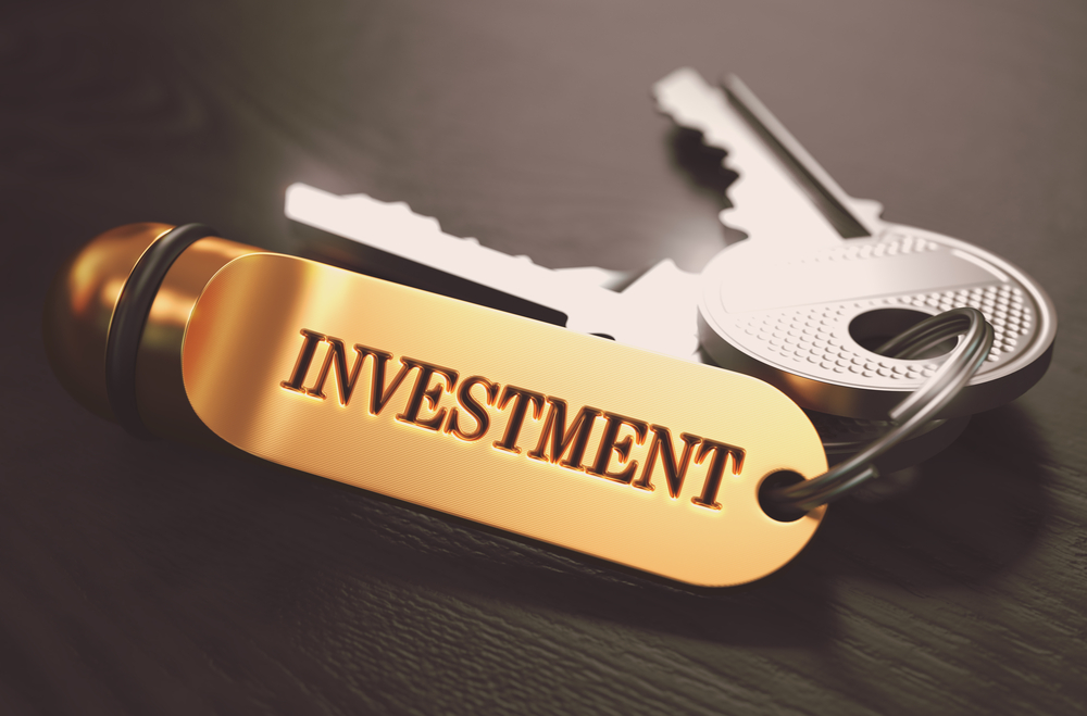 Keys with the word Investment on golden label